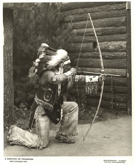 American Indian Demonstrating The Use Of A Bow And Arrow A Photo On
