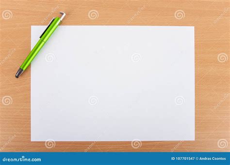 White Blank Paper Sheet With A Pen On A Wooden Table Stock Image
