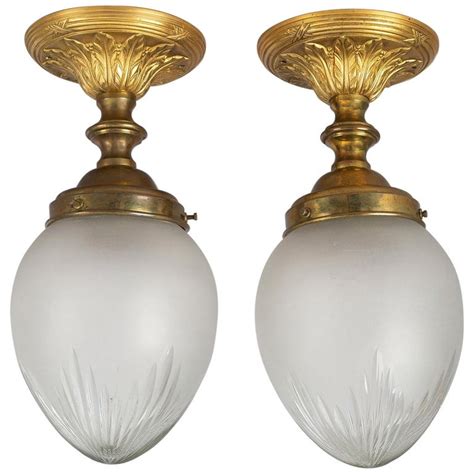Making a room look larger than it really is can be done by reflecting light off its ceiling. Pair of Cut-Glass Ceiling Lights For Sale at 1stdibs