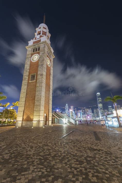 Old Clock Tower And Skyline In Hong Kong City At Night Stock Photo