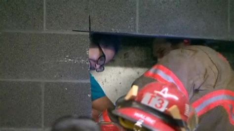 woman trapped in tiny gap between building walls bbc news