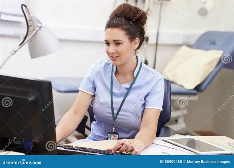 Female Nurse Working At Desk In Office Stock Photo Image Of