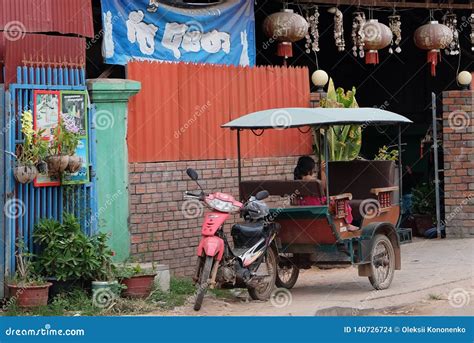 Little Asian Girl Sits In A Moto Rickshaw Near A House With Red Lanterns Editorial Stock Image