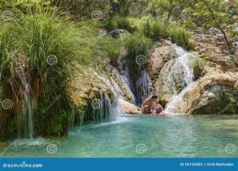 Couple Hugging And Kissing Under Waterfall Stock Photography