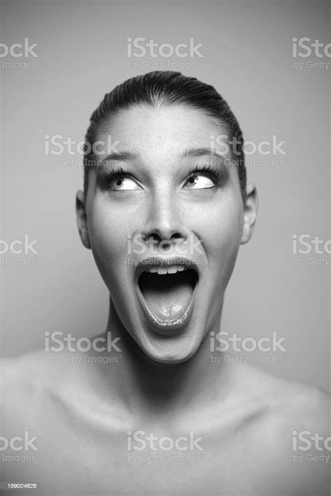 Portrait Of Beautiful Surprised Woman Looking Up Stock Photo Download