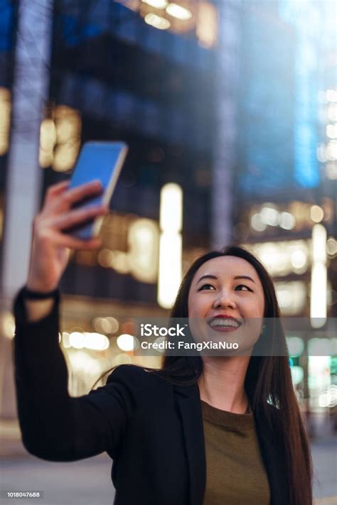 Young Lady Taking Selfies On City Street Stock Photo Download Image