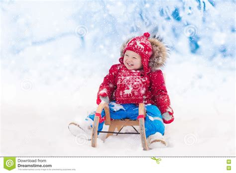 Kids Play In Snow Winter Sleigh Ride For Children Stock