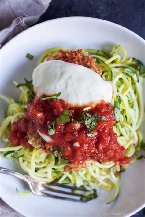 Place one slice of mozzarella over each chicken piece and evenly sprinkle grated parmesan on top. Lighter Baked Chicken Parmesan with Zucchini Noodles | Zoodles
