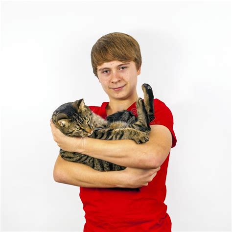 Teen Boy Holds His Tabby Cat In His Arms Stock Photo Image Of Young