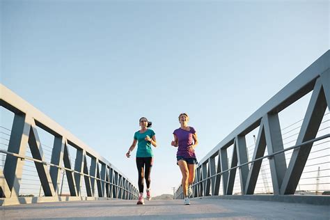 Healthy Mature Women On Urban Morning Run Together By Stocksy
