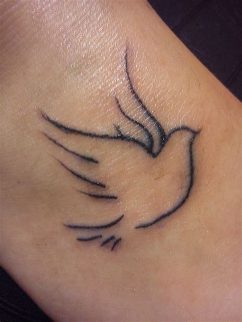 A splash of spanish text complete the look. Elegant Dove Outline Tattoo - CreativeFan