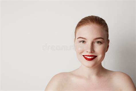 Handsome Redhead Female Model With Light Nude Make Up Posing Over White
