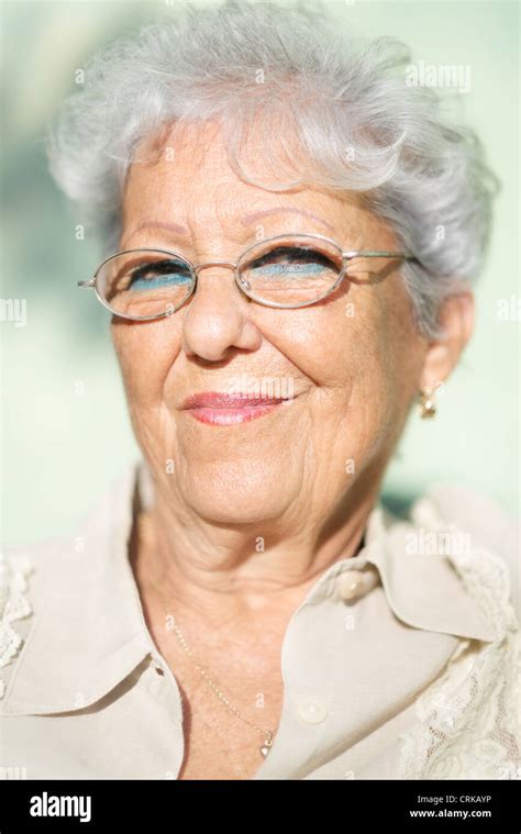 Portrait Of Senior Caucasian Woman With Glasses Looking At Camera And