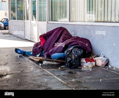 Homeless Man Sleeping On The Street And Covered With Blanket Homeless
