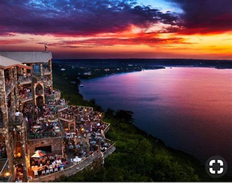 An Aerial View Of A Restaurant Overlooking The Water At Sunset Or Dawn