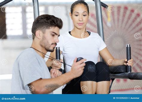Young Beautiful Woman Doing Exercises With Personal Trainer Stock Image