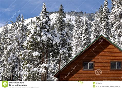 Winter Cabin With Snow Covered Roof Royalty Free Stock