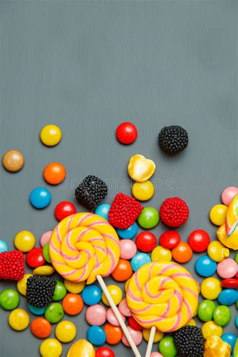 Colorful Lollipops Candy Canes And Sweet Candies Mix On Gray Wooden