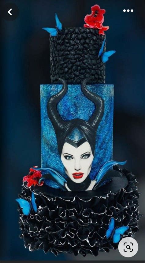 The Cake Is Decorated With Black And Blue Icing Red Flowers And An Evil Woman S Head