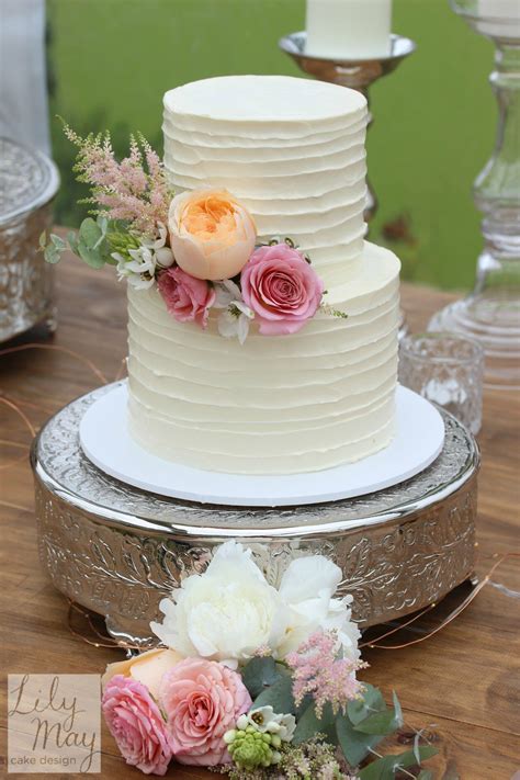 gorgeous two tier rustic textured buttercream wedding cake finished with romantic f