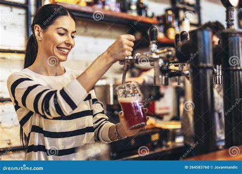 Female Bartender Tapping Beer In Bar Stock Photo Image Of Positive