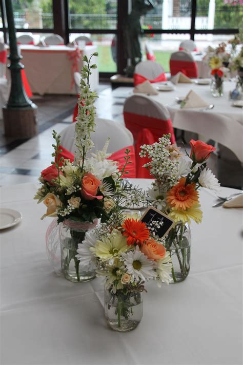 You are given choices of flower types, bunch sizes. Canning jar centerpieces with a mix peach, coral, white ...