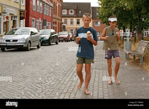 Barefoot Boys Walking Through Town Stock Photo Alamy