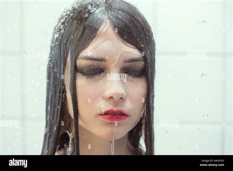 Close Up Portrait Of A Wet Crying Woman Under Shower Splashes Toned