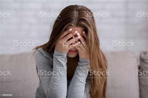 Millennial Woman Covering Her Face With Hands And Crying Feeling
