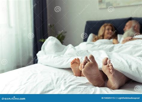 Feet Of Happy Mature Couple Resting Together In Bed Stock Image Image