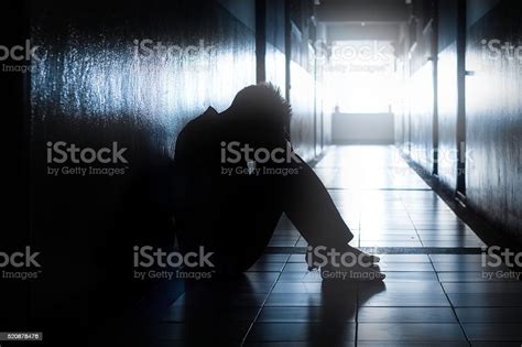 Sad Or Hopeless Man Sit In Dark Location Stock Photo Download Image