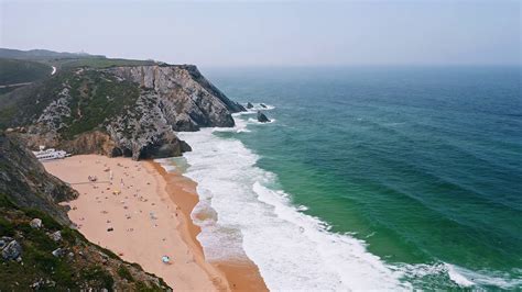 4k Aerial View Of Praia Da Adraga Beach White Atlantic Ocean Waves