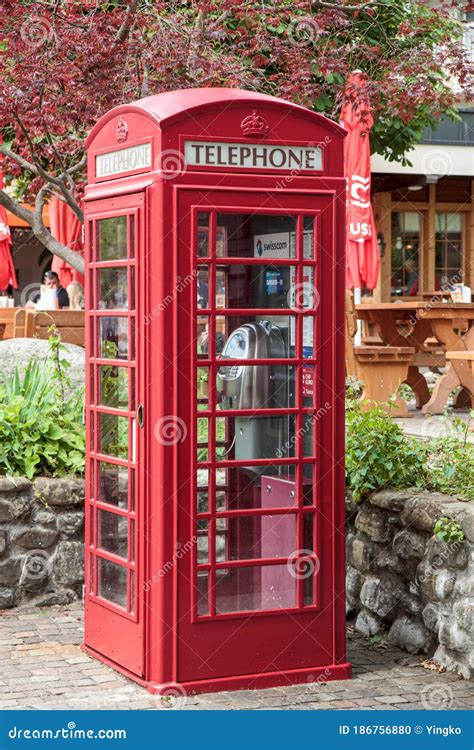 Swisscom Public Phone In Classic Red Telephone Booth Editorial Image