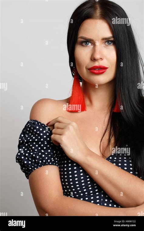 Beautiful Brunette With Red Earrings Stock Photo Alamy
