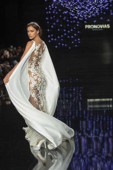 A Model Walks Down The Runway In A White Gown