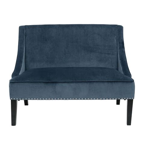 A Blue Velvet Couch With Studded Legs
