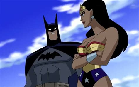 batman and wonder woman standing next to each other