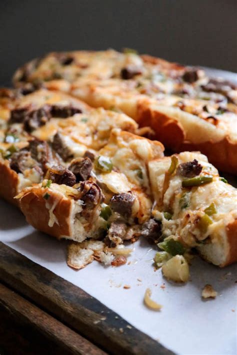 Philly cheese steak cheesy bread with just a few ingredients is the taste of philly for a crowd! Cheesy Philly Cheesesteak Bread - Country Cleaver