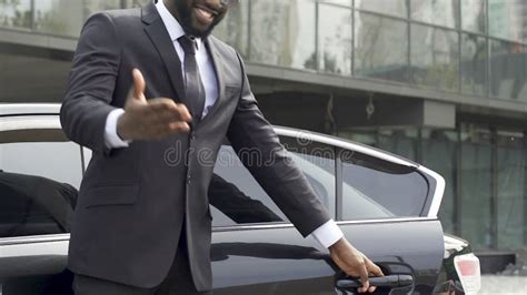 Luxury Taxi Driver Opening Door For Wealthy Client Inviting For Ride Services Stock Video
