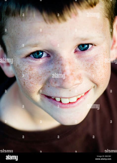Happy Smiling Young Boy With Bright Clear Blue Eyes And Freckles Stock