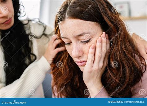 Sad Young Teenage Girl Comforted By Her Friend At Home Stock Image