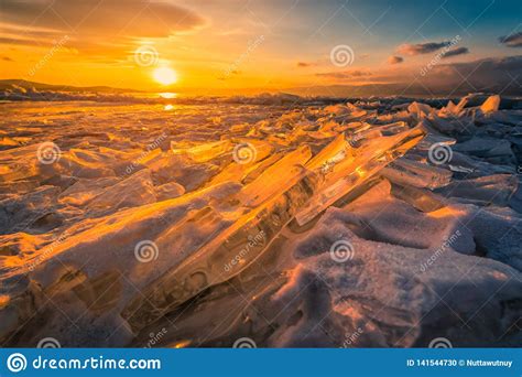 Sunset Sky With Natural Breaking Ice Over Frozen Water On