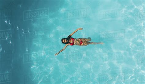 Aerial View Of Woman Swimming In Resort Pool Top View Of Female