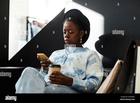 Graphic Portrait Of Elegant Black Woman Wearing Hat While Relaxing At