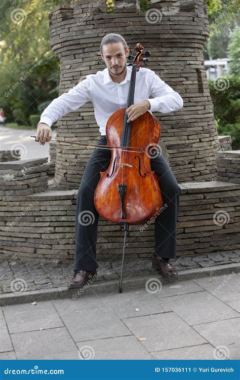 Young Man Playing Cello Outside Cellist Playing Classical Music On