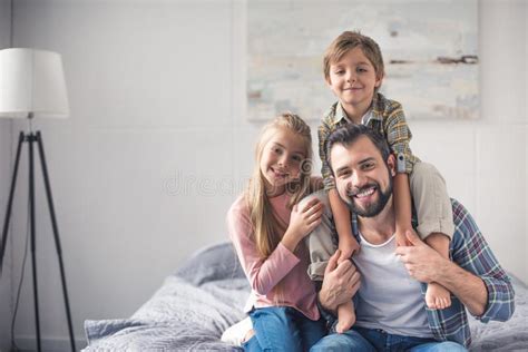 Portrait Of Cheerful Siblings And Father Looking Stock Photo Image Of