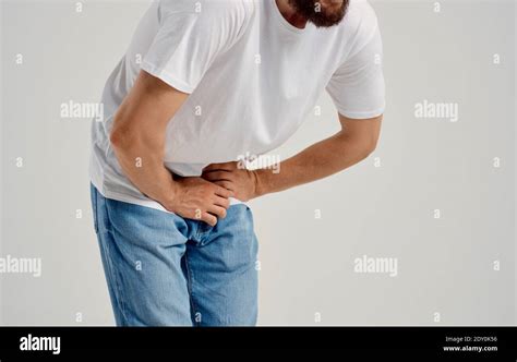 Man Experiencing Pain Below The Belt In The Groin And Jeans T Shirt