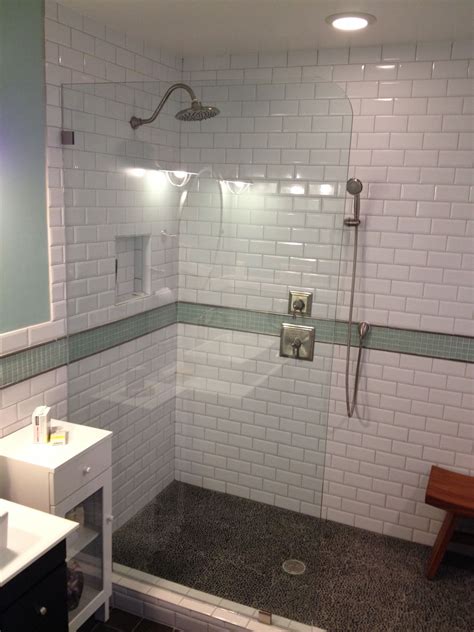 Shower floor tiles at westside tile & stone. Finished walk in shower. 3/8" tempered glass. Black pebble ...