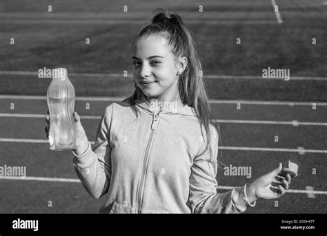 Thirsty And Hydration Teen Girl Drink Water On Stadium Kid In