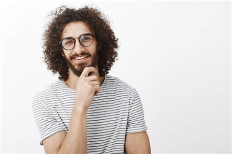 좋은 생각 이네요 유행 안경에 수염과 곱슬 머리를 가진 관심이 스마트 잘 생긴 성인 남자의 초상화 무료 사진